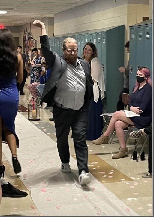 Teacher Paul Lichtenauer dancing in the hallway
