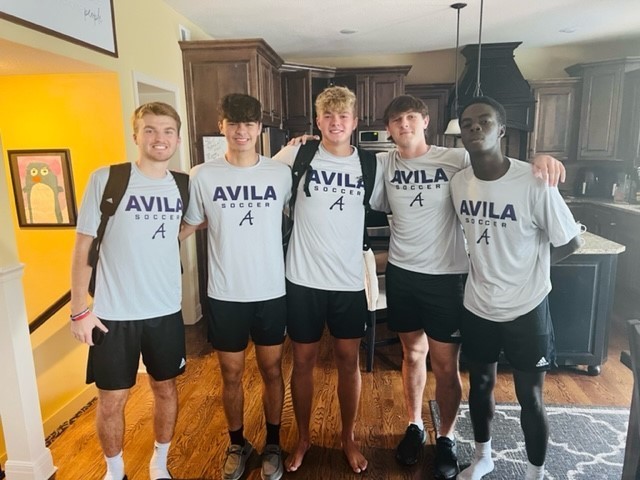 Five young men wearing Avila University shirts