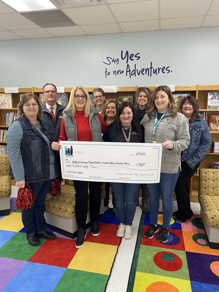 Success Academy Staff hold giant check